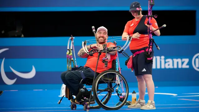 Nathan Macqueen and Jodie Grinham in archery action