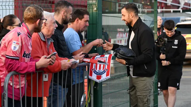 Narcis Pelach signs autographs for Stoke fans before his first match in charge of the Potters.