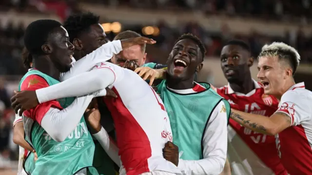 Monaco players celebrate winning against Barcelona