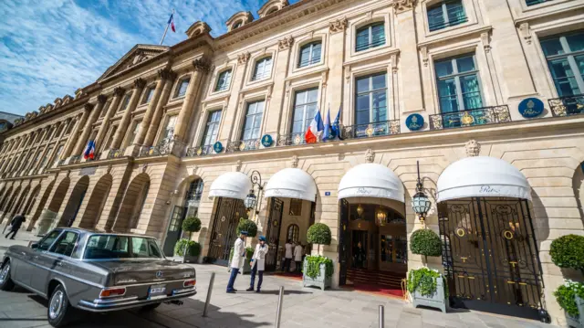 Hotel Ritz on Place Vendome, Paris. Concierges at the entrance. Old Mercedes car is parked at the entrance.