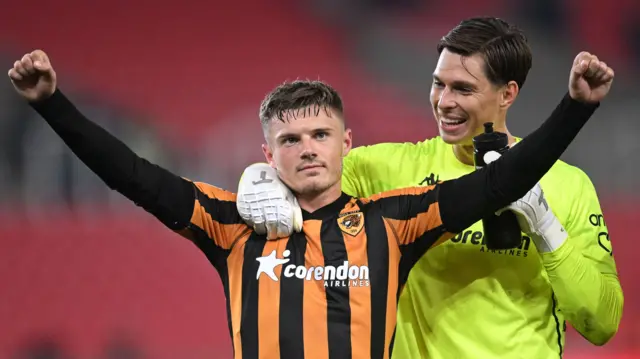 Hull City goalscorer Regan Slater raises both arms after their victory at Stoke.