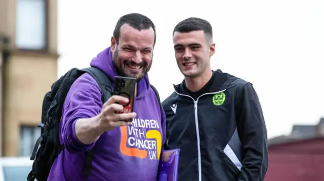 MOTHERWELL, SCOTLAND - SEPTEMBER 20: A Motherwell fan takes a selfie with Motherwell's Lennon Miller during a Premier Sports Cup quarter-final match between Motherwell and Dundee United at Fir Park, on September 20, 2024, in Motherwell, Scotland. (Photo by Craig Foy / SNS Group)