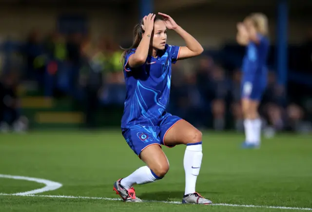 Reiten puts her hands to her head in disbelief