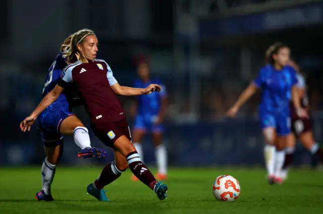 Nobbs passes the ball to a teammate