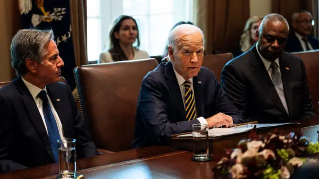 US President Joe Biden (C) speaks next to US Secretary of State Antony Blinken (L) and US Secretary of Defense Lloyd Austin (R), during a cabinet meeting at the White House in Washington