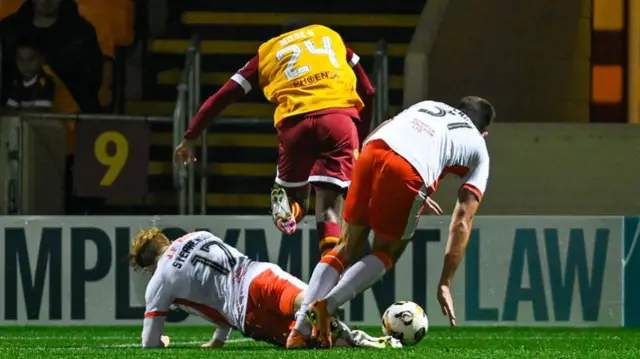 MOTHERWELL, SCOTLAND - SEPTEMBER 20: Dundee United's Luca Stephenson fouls Motherwell's Moses Ebiye which results in a late penalty for Motherwel during a Premier Sports Cup quarter-final match between Motherwell and Dundee United at Fir Park, on September 20, 2024, in Motherwell, Scotland. (Photo by Rob Casey / SNS Group)