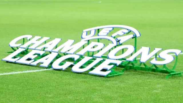 A Champions League sign lay on a football pitch