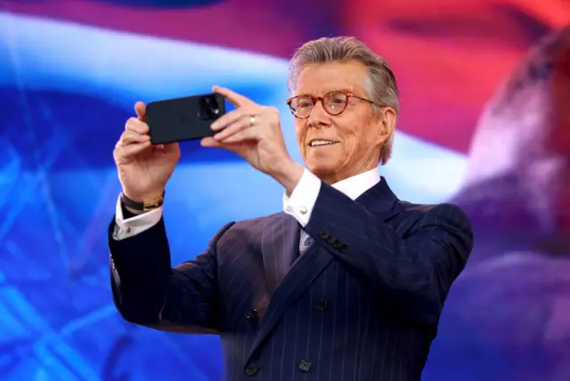 Michael Buffer holds up his phone