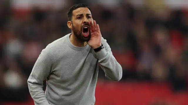 Stoke City head coach Narcis Pelach shouts instructions from the touchline.