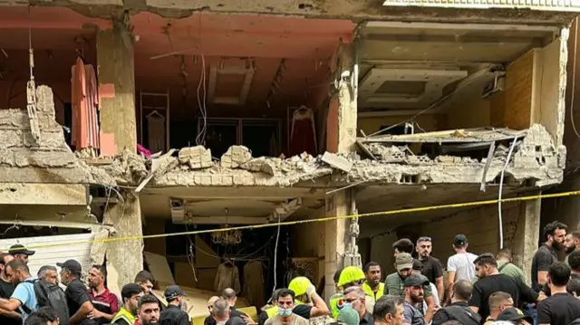 Destroyed building, where walls appear to have been blown off, in Beirut