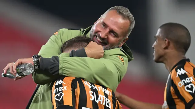 Hull manager Tim Walter hugs goalscorer Regan Slater.