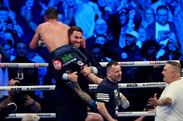 Josh Warrington is lifted in the air by Eddie Hearn