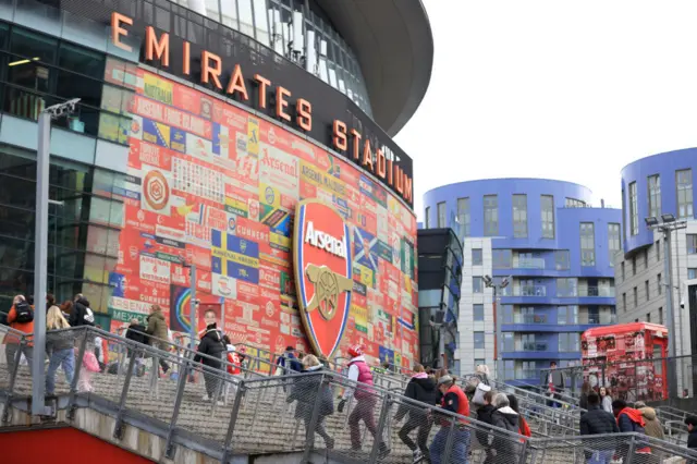 Arsenal fans arrive at Emirates Stadium for the game