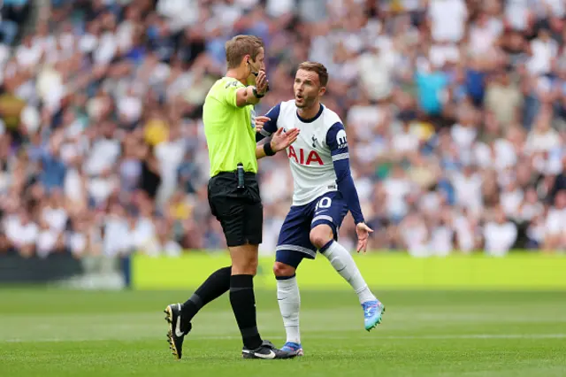 Referee John Brooks gestures as James Maddison