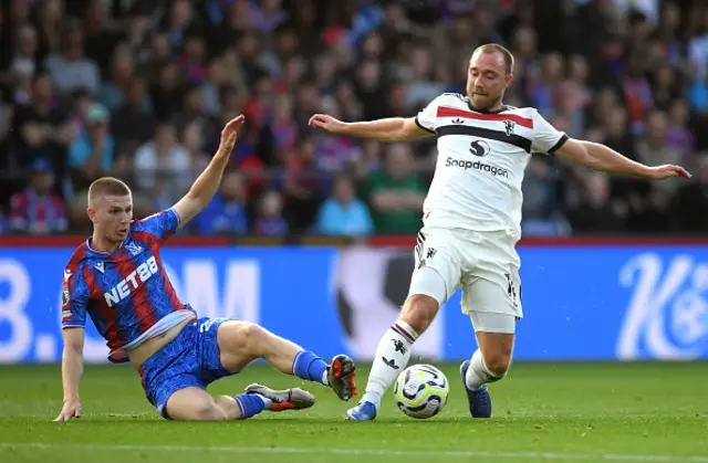 Christian Eriksen of Manchester United is challenged by Adam Wharton