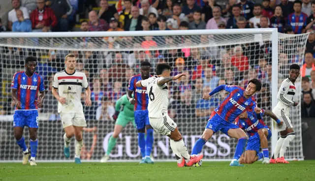 Daichi Kamada of Crystal Palace is challenged by Lisandro Martinez