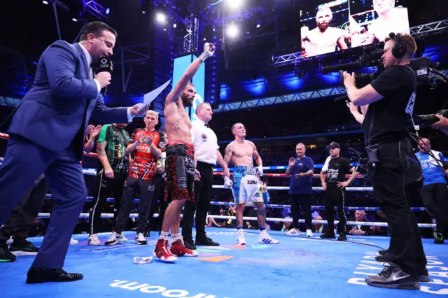 Anthony Cacace has his hand raised as he is announced the winner over Josh Warrington