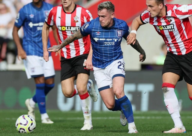 Ipswich Town's Sam Szmodics in action with Southampton's Taylor Harwood-Bellis