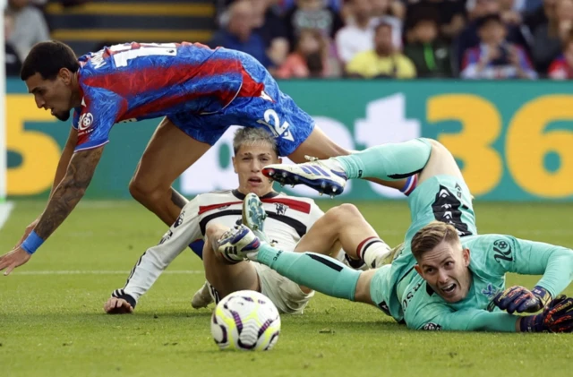 Dean Henderson in action with Manchester United's Alejandro Garnacho