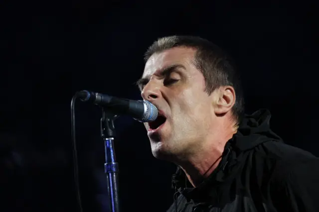 Liam Gallagher sings on the microphone