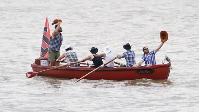 A boat passes under Tower Bridge in central London, as they take part in the Great River Race which brings together up to 300 boats and 1500 people rowing from Millwall in East London to Richmond, to raise money for charities. Each year, traditional style boats race each other over the 21.6mile course, with many competitors joining from around the world. Picture date: Saturday September 21, 2024.