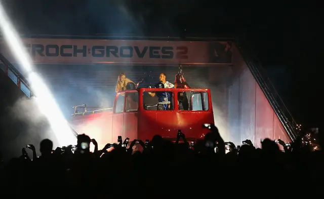 George Groves stands on the top of an open top bus in Wembley stadium