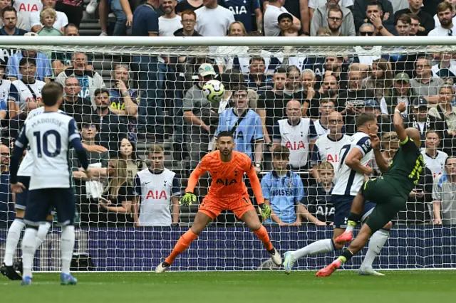 Bryan Mbeumo (R) shoots to score