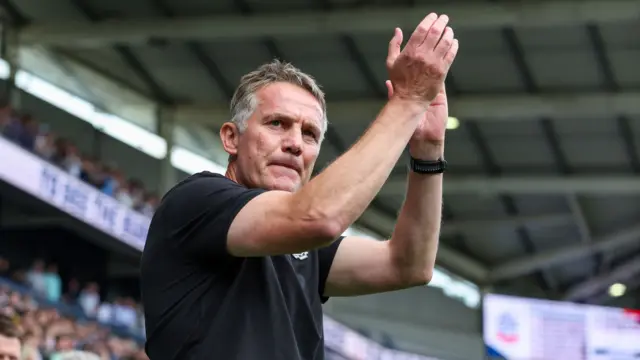 Wrexham manager Phil Parkinson claps supporters.