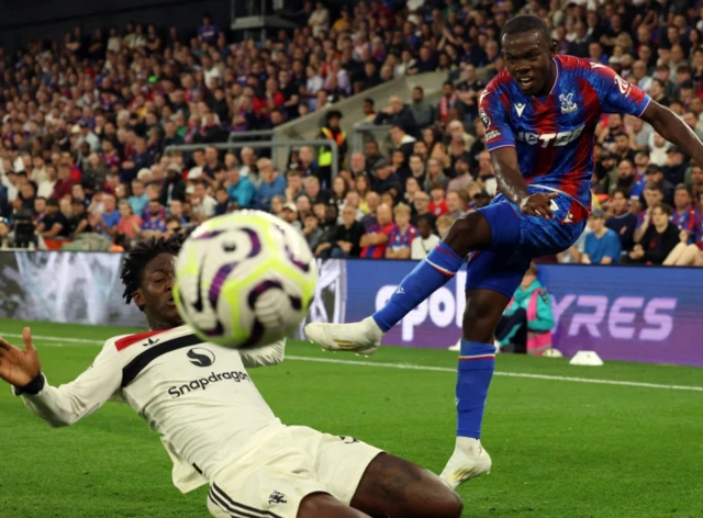 Manchester United's Kobbie Mainoo in action with Crystal Palace's Tyrick Mitchell