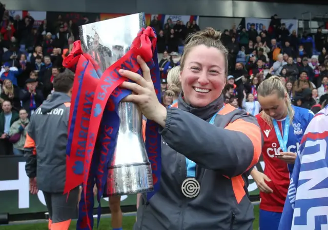 Laura Kaminski holds aloft the WC trophy