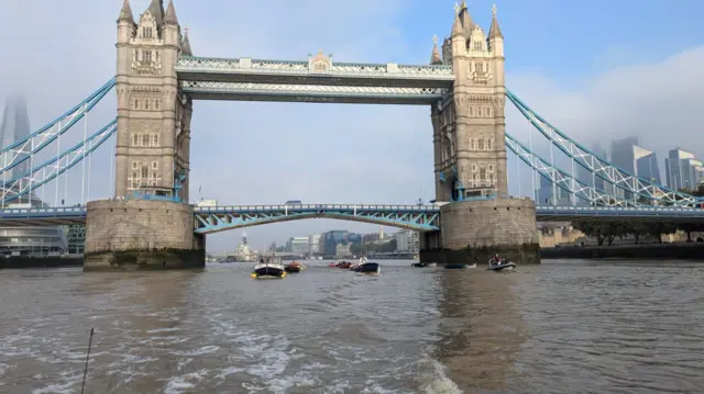 Boats making their way under Tower Bridge