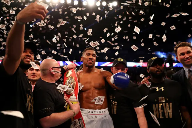 Anthony Joshua celebrates with his world title