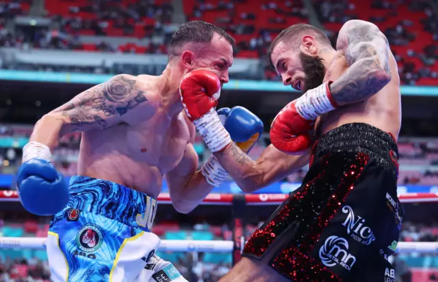 Josh Warrington is punched on the chin by Anthony Cacace