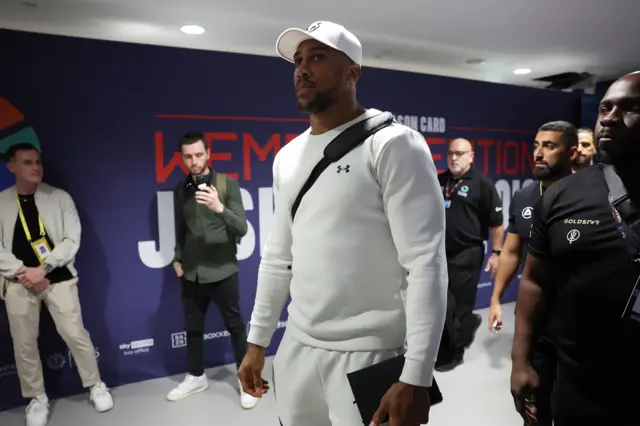 Anthony Joshua backstage in a white tracksuit