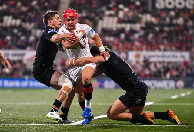 Ulster's Mike Lowry is tackled by Sebastian Cancelliere and Josh McKay