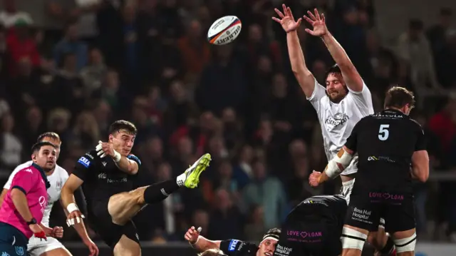 Glasgow's Jamie Dobie attempts to kick clear of Iain Henderson's block