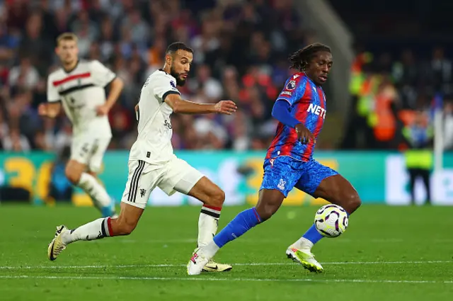 Eberechi Eze of Crystal Palace is challenged by Noussair Mazraoui