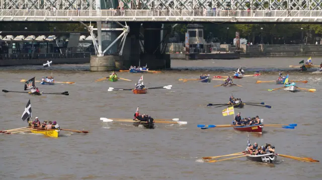 Multiple boats on the Thames passing under Westminster Bridge