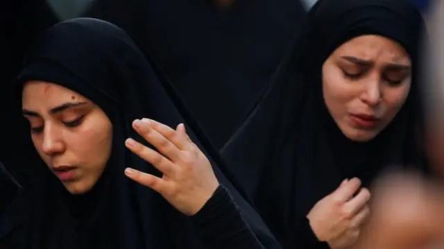 Two women, one crying, near the scene of an Israeli strike on a Beirut suburb on 20 Fri Sept