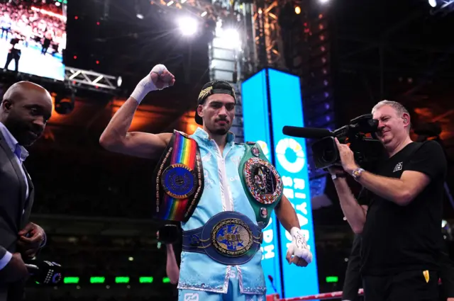 Hamzah Sheeraz with his titles in the ring