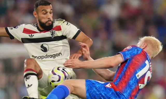 Noussair Mazraoui (left) and Crystal Palace's Will Hughes battle for the ball