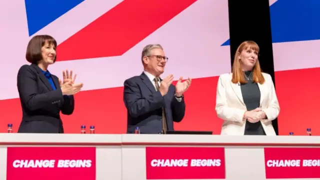 Britains chancellor of the exchequer Rachel Reeves (L) and Britain's Prime Minister, Keir Starmer (C), applaud Britains Deputy Prime Minister, Angela Rayner (R), after she delivered her keynote speech to the Labour Party Conference 2024 at ACC Liverpool on September 21, 2024 in Liverpool, England