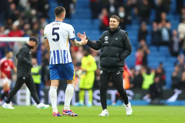 Dunk celebrates with Brighton boss Hurzeler