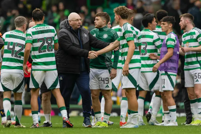 John McGlynn congratulates the Celtic players at full-time