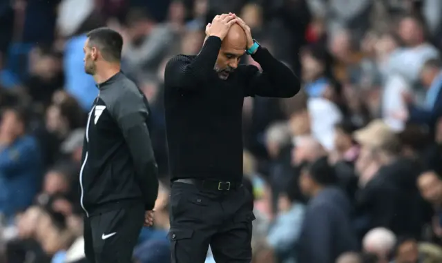 Guardiola with hands on his head