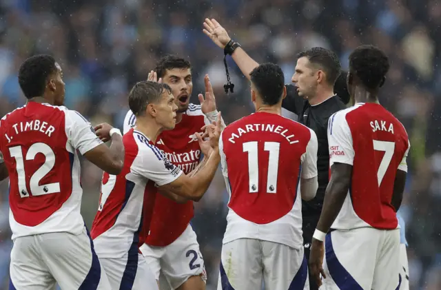 Arsenal players remonstrate with the referee