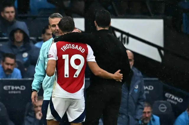 Trossard and Arteta embrace as he leaves the pitch