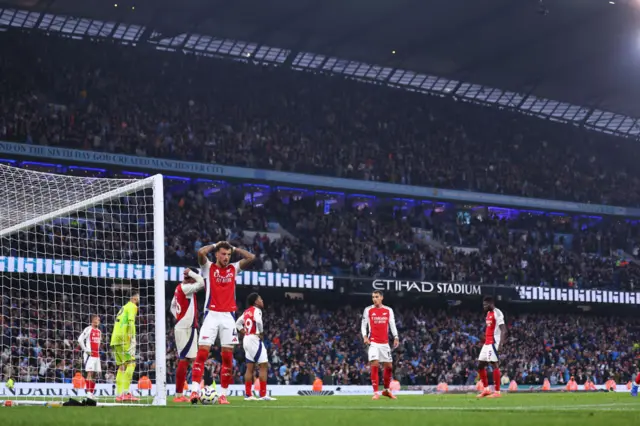 Arsenal players look devastated after City score their second