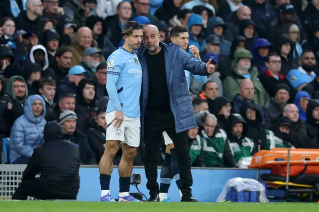 Grealish prepares to come on