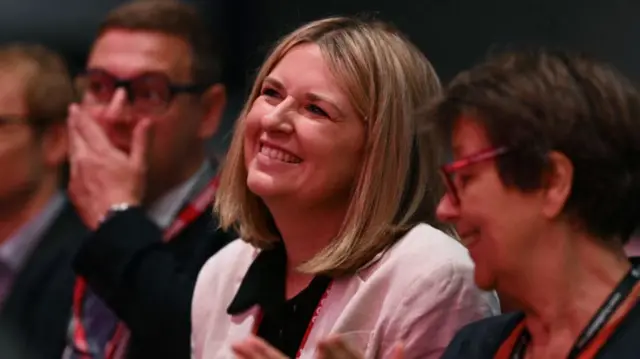 Labour's new general secretary Hollie Ridley smiles in the audience on the first full day of the annual Labour Party conference in Liverpool